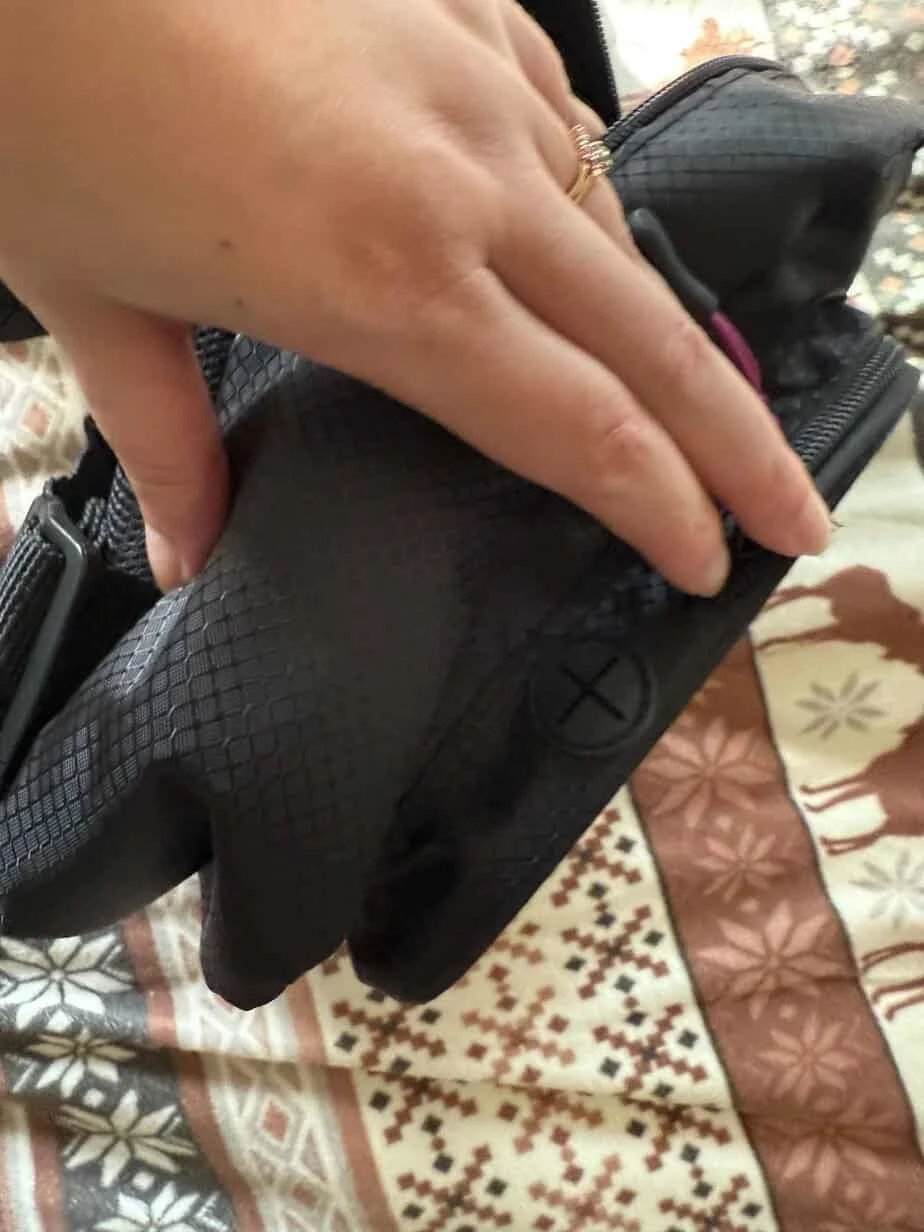 Cabeau On the Go Sling Pack Front Zip Pouch with Headphone Passthrough